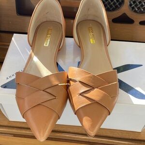 BCBGMAXAZRIA pointed-toe flats in a tan